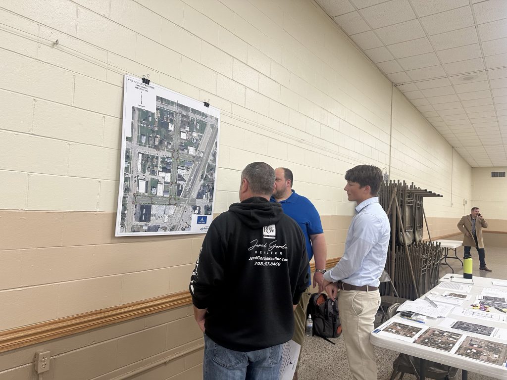 Realtor and property owner Jared Gordon talked with Robinson Engineering at the Streetscape Open House.  About 80 people came out for the open house during the worst weather of the week. Photo by Andrea Arens.