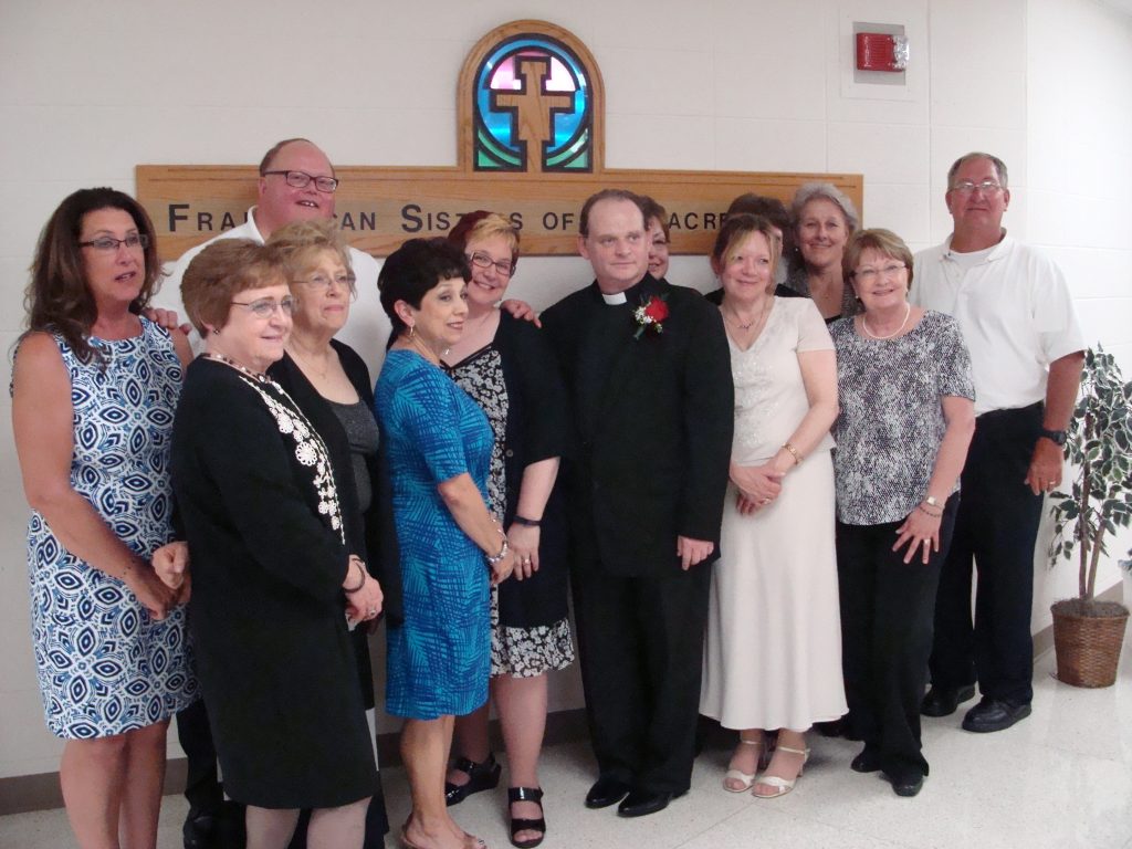 Rev. Kutzner with parishioners. –Photo by Karen Haave.