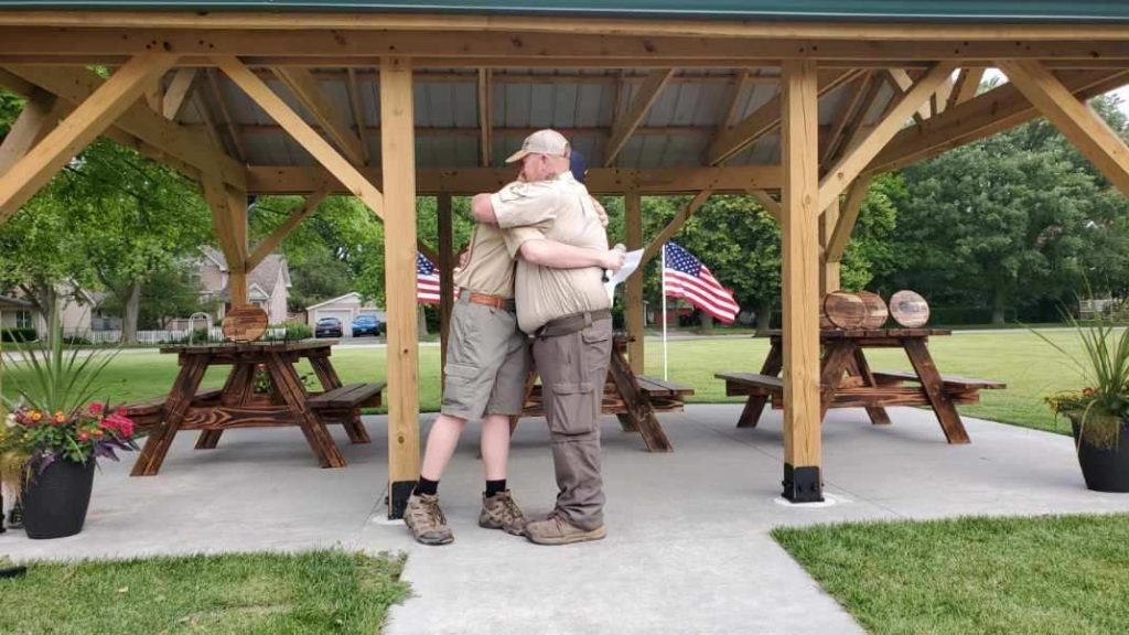 Aidan Steffan and his Dad, Scoutmaster Dan, share a hug after being presented with the service award. –Photo submitted.